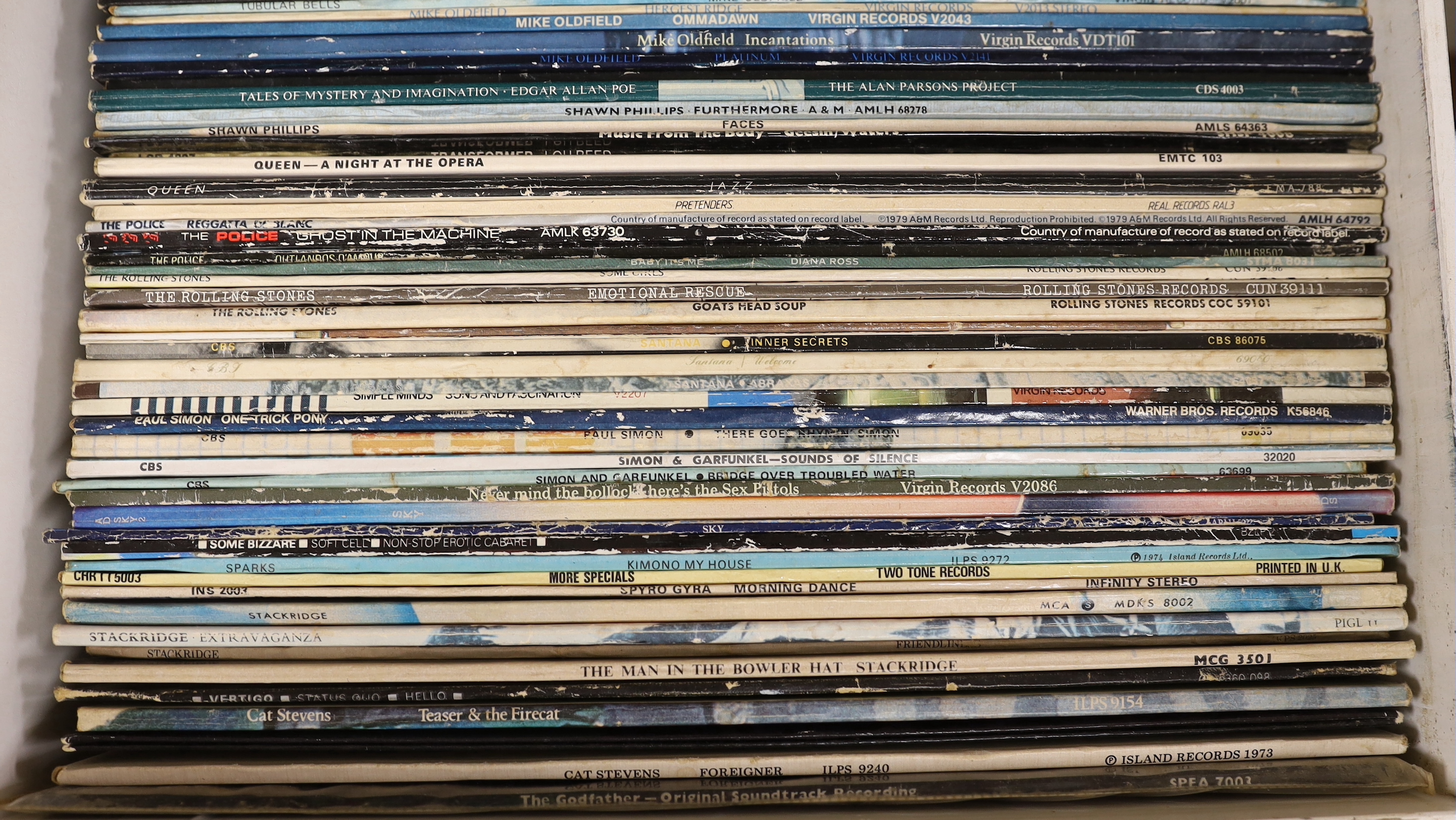 Fifty-eight LP record albums by artists including; Cat Stevens, The Sex Pistols, Simon & Garfunkel, Rolling Stones, the Police, Queen, Lou Reed, Mike Oldfield, Uriah Heep, Ultravox, etc.